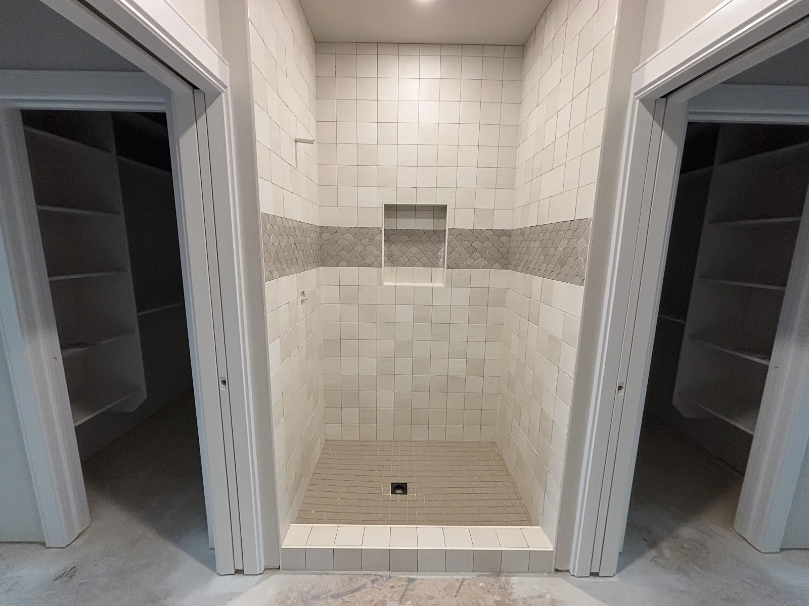 Finished shower with tile and a stone-look accent band